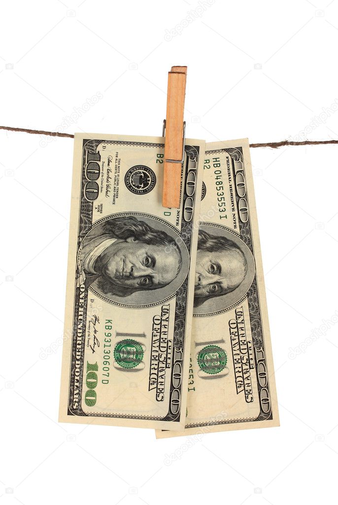 Two one hundred dollar bills is hanging on a rope with wooden clothespin is