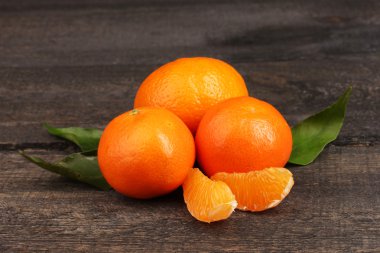 Tangerines with leaves on wooden grey table