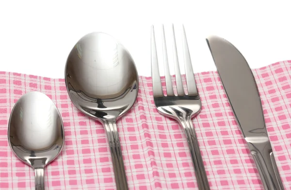 Fork, spoon and knife in a plaid cloth with a bow isolated on white — Stock Photo, Image