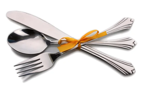 Серебряная вилка и ложка, нож, перевязанный желтой лентой, изолированный на белом — стоковое фото