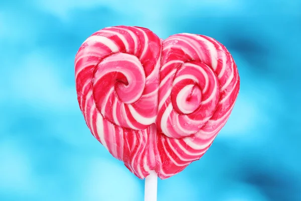Delicious candy on stick on blue background — Stock Photo, Image