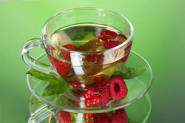 Green tea in transparent cup with mint and berry — Stock Photo, Image