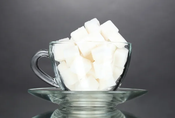 Refined sugar in a cup on gray background — Stock Photo, Image