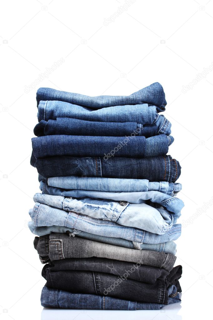 Lot of blue jeans isolated on white