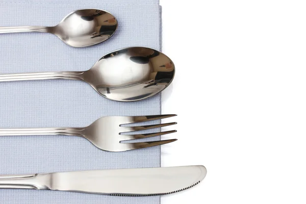 Fork, spoon and knife in a blue cloth isolated on white — Stock Photo, Image