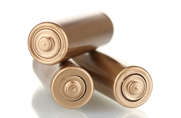 Tři zlaté baterie izolovaných na bílém — Stock fotografie
