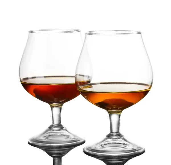 Two glasses of cognac on grey background — Stock Photo, Image