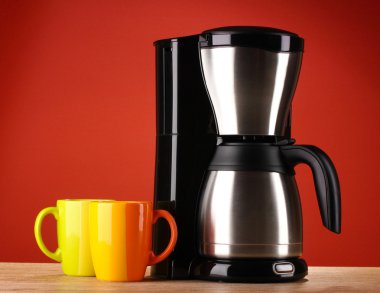 Coffee maker on red background clipart