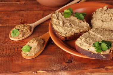 Fresh pate with bread on wooden table clipart