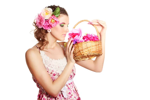 Gyönyörű lány, virágokkal a hajában, és egy kosár virágot isolat — Stock Fotó
