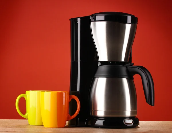 Coffee maker on red background — Stock Photo, Image