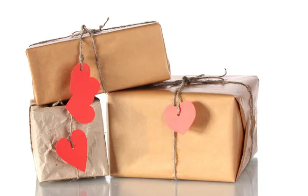 Três pacotes com rótulos em forma de coração em branco isolados em branco — Fotografia de Stock