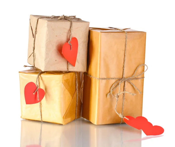 Três pacotes com rótulos em forma de coração em branco isolados em branco — Fotografia de Stock
