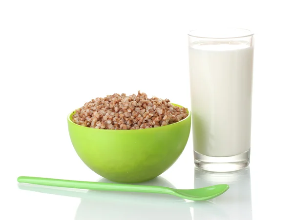 Boiled buckwheat in a green bowl with a glass of milk isolated on white — Stock Photo, Image