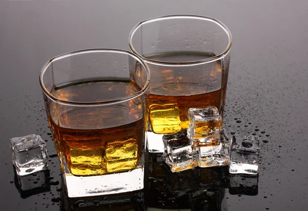 Gri masada iki bardak viski ve buz. — Stok fotoğraf