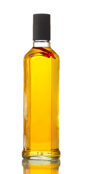 Bottle of vodka with pepper isolated on white Stock Photo