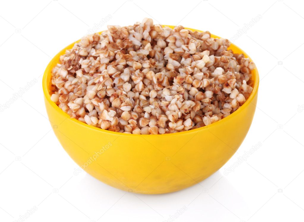 Boiled buckwheat in a yellow bowl isolated on white