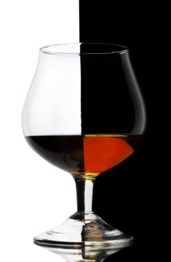 Glass of cognac on white-black background clipart