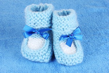 Blue baby booties on blue background