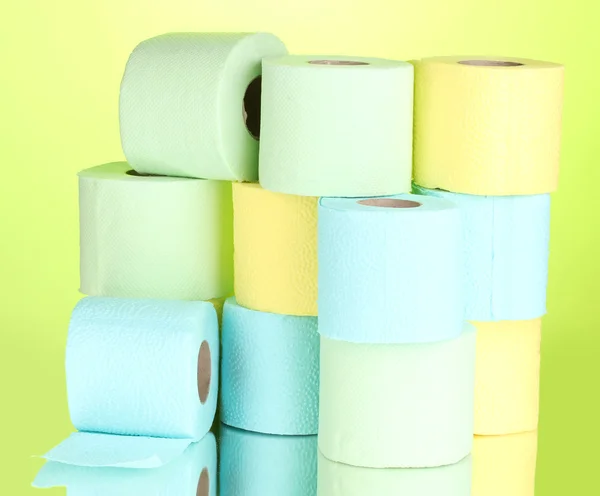 Bright rolls of toilet paper on green background — Zdjęcie stockowe