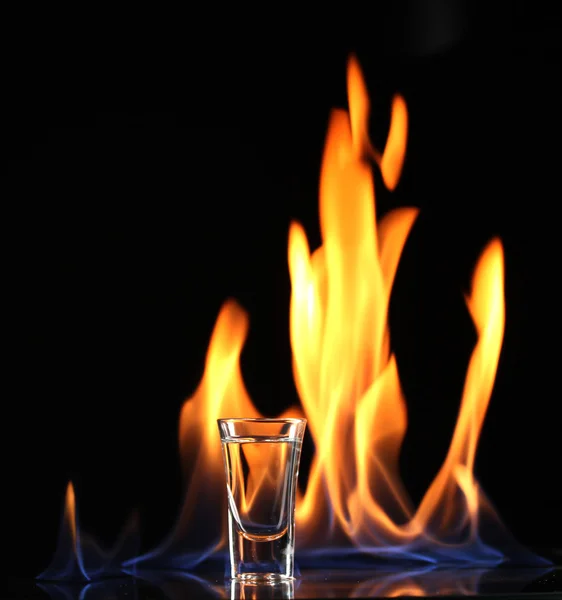 Flaming vodka on black background — Stock Photo, Image