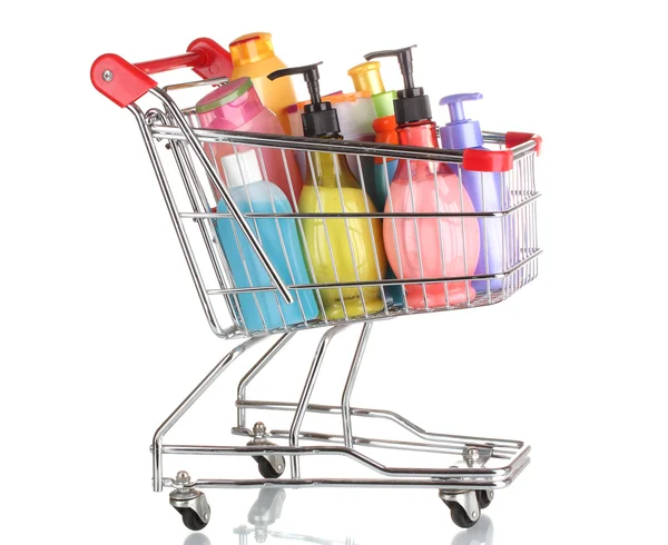 Carrinho de compras com garrafas de detergente isolado em branco — Fotografia de Stock