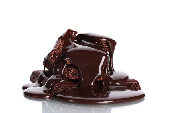 Slices of milk and dark chocolate bar poured chocolate isolated on white