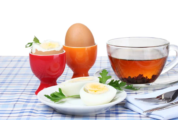 Lækker morgenmad med kogte æg og te - Stock-foto