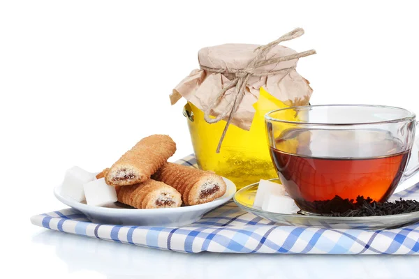 Leckeres Frühstück mit Tee, Keksen und Honig auf grauem Hintergrund — Stockfoto