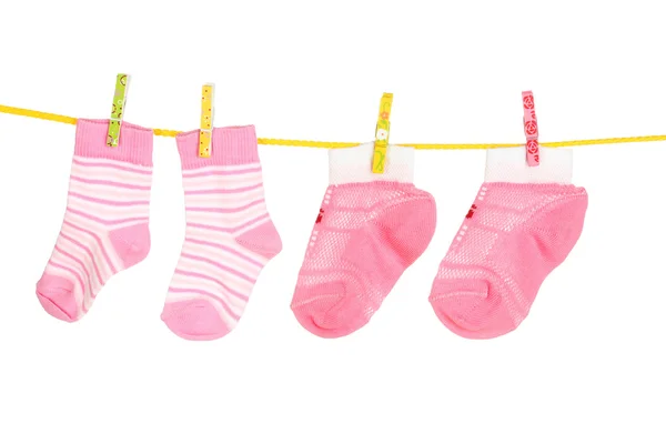 Pink baby socks on rope isolated on white — Stock Photo, Image