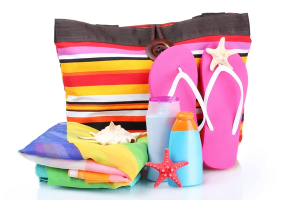 Bright striped beach bag and beach items isolated on white — Stock Photo, Image