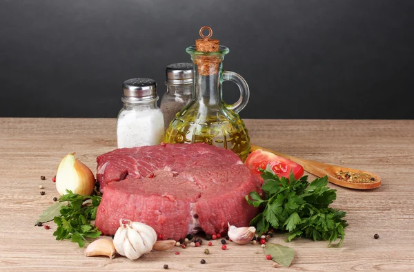 stock image Raw meat, vegetables and spices on gray background