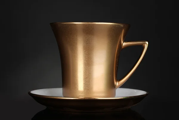 Golden cup of coffee on gray background — Stock Photo, Image