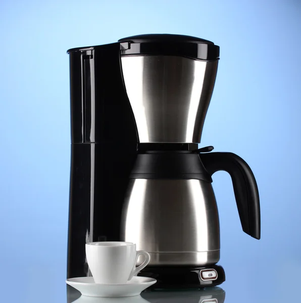 Coffee maker with white cup on blue background — Stock Photo, Image