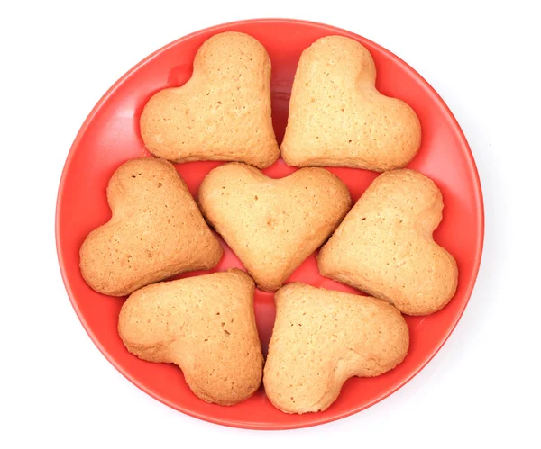 Heart-shaped cookies on red saucer isolated on white — Stock Photo, Image