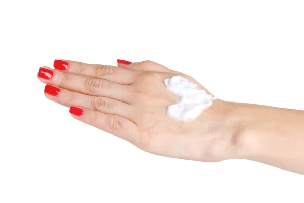 Vrouwelijke hand met manicure en hart gemaakt van crème geïsoleerd op wit — Stockfoto