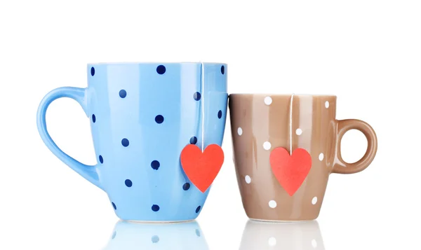 Dos tazas y bolsas de té con etiqueta roja en forma de corazón aislada en blanco —  Fotos de Stock