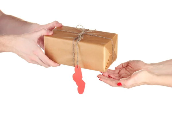 Man's hand giving parcel with blank heart-shaped label to woman isolat — Stock Photo, Image