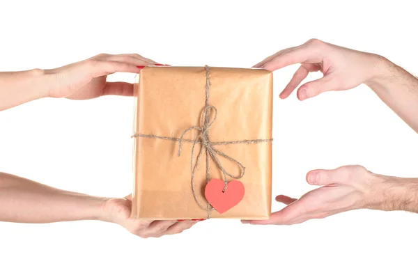Woman's hand giving parcel with blank heart-shaped label to man isolat — Stock Photo, Image