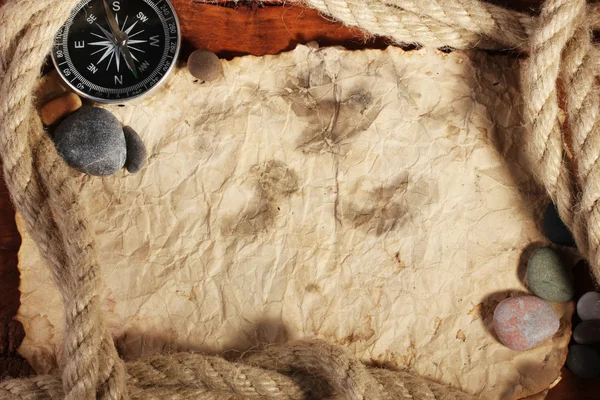 stock image Old paper, compass and rope on a wooden table