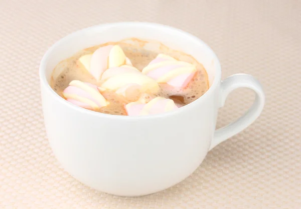 Cup of cappucino with marshmallows on beige background — Stock Photo, Image