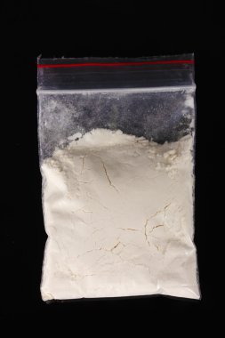 Cocaine in package on black background clipart