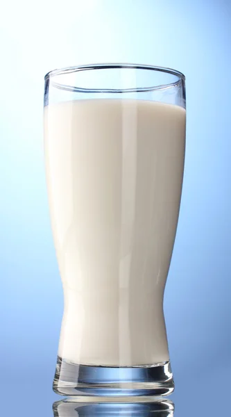 Glass of milk on blue background — Stock Photo, Image