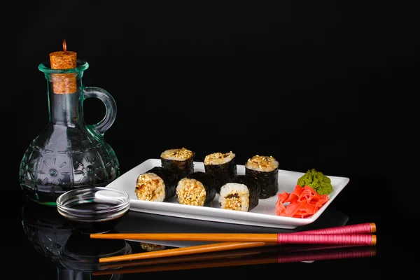 Tasty rolls served on white plate with chopsticks and soy sauce — Stock Photo, Image