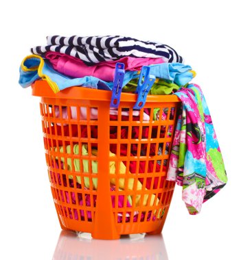 Clothes in orange plastic basket isolated on white clipart