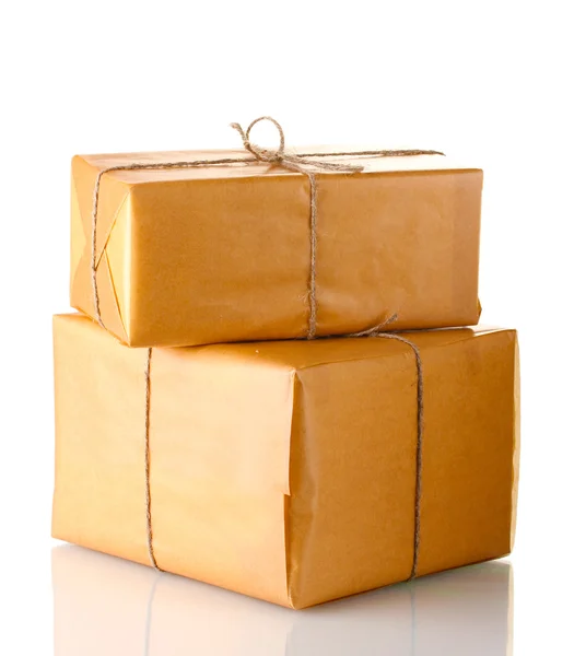 Two parcels wrapped in brown paper tied with twine arranged in stack isolat — Stock Photo, Image