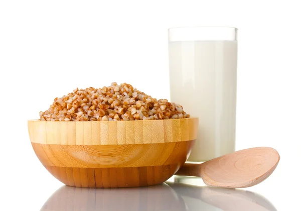 Boiled buckwheat in a wooden bowl with a glass of milk isolated on white — Stock Photo, Image