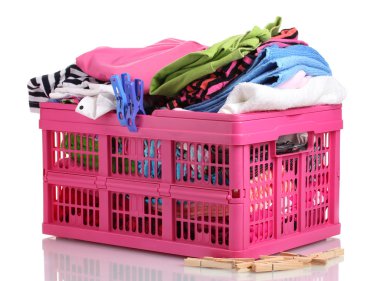 Clothes in pink plastic basket isolated on white clipart