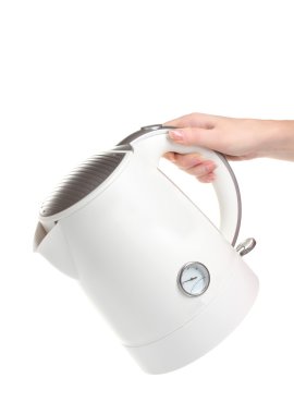 Womens hand and white electric kettle isolated on white clipart