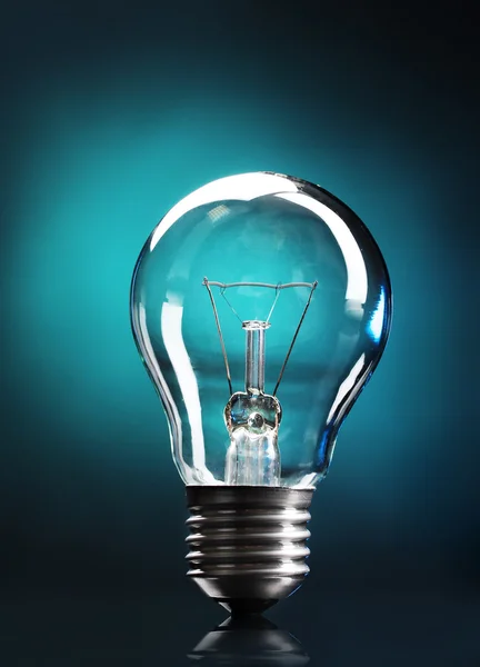 stock image Light bulb on blue background